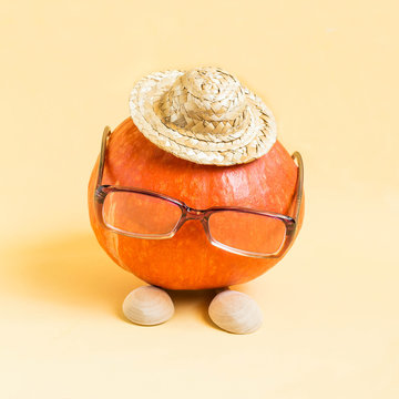 Pumpkin in form of funny little man in hat and glasses