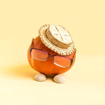 Pumpkin in form of funny little man in hat and glasses