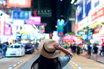 Tourist is enjoy traveling in famous night market in Mong Kok, Hong Kong.