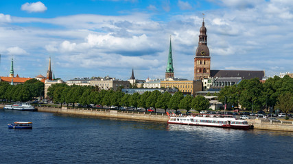 Obraz premium Panoramic view across Daugava river with cruise chip and Riga cathedral in old town, Latvia, July 25, 2018