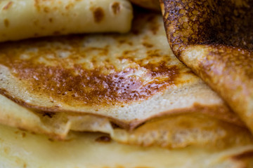 Appetizing golden pancakes with crispy crust, cooked at home. Fatty and hot pancakes on milk