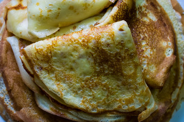 Appetizing golden pancakes with crispy crust, cooked at home. Fatty and hot pancakes on milk