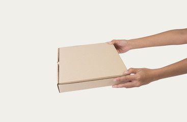 Hand holding cardboard brown paper box for pizza mockup branding.