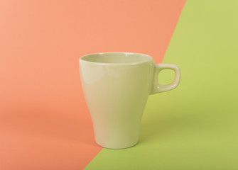 Green coffee cup on color background. mockup for creative design branding.