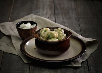 Russian traditional dumplings in the wooden table in a rustic style
