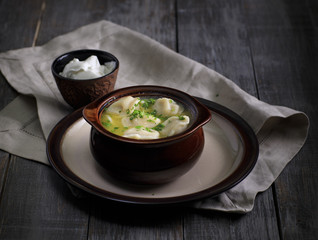 russian style food. Dumplings pelmeni in the wooden table. rustic