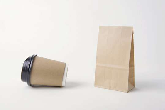 Blank brown paper bag and coffee cup for mockup template advertising and branding background.