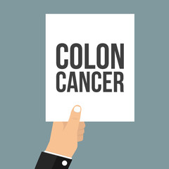 Man showing paper COLON CANCER text
