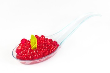 Plastic spoons with fish caviar on a white background. 