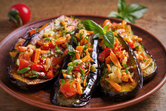 Eggplants with tomatoes, paprika, carrot, onion and garlic. Aubergine with vegetables. overhead, horizontal