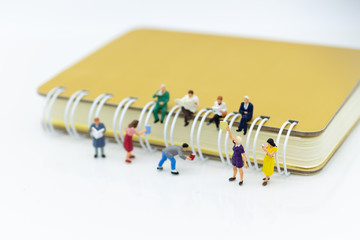 Miniature people: Student reading book with big book, library. Image use for education concept.