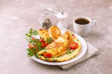 Herb omelette with tomatoes and panini toasts. Coffee. Breakfast