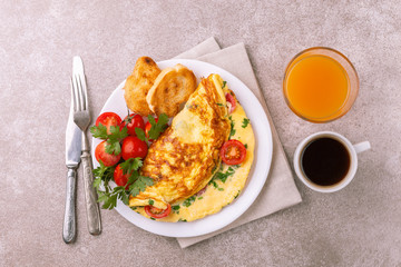 Herb omelette with tomatoes and panini toasts. Coffee. Breakfast