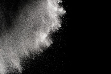 Freeze motion of white particles on black background. Abstract white dust explosion. 