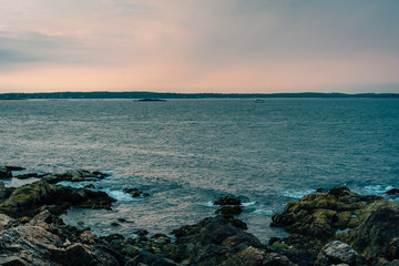 Sunset over rocky coast at Chandler Hovey Park, in Marblehead, Massachusetts