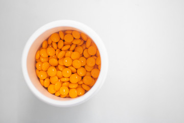orange medicine pills in can top view