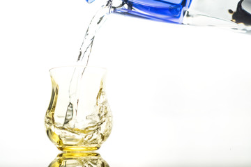 Close up of a fresh drink of water from a bottle in the studio on a white background