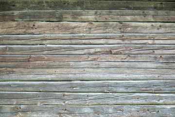 Grunge background of natural old hewn logs.