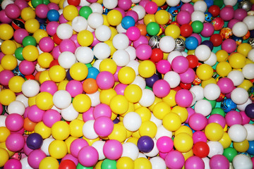 Many colorful plastic balls in a kids ballpit at playground