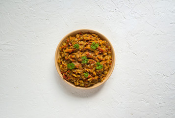 A plate of eggplant caviar on a white table. Cold vegetable appetizer.
