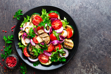 Salad with fresh and grilled vegetables and mushrooms. Vegetable salad with grilled champignons. Vegetable salad on plate. Healthy vegetarian food