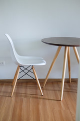Interior of modern apartment with wooden table and chair
