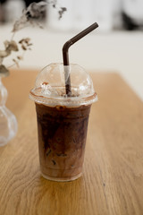 Ice coffee in a glass on wood table