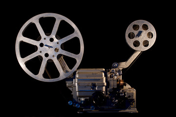 Naklejka premium movie projector on black background