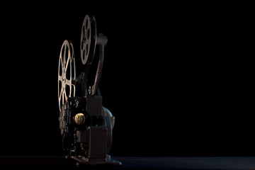 movie projector on black background - obrazy, fototapety, plakaty