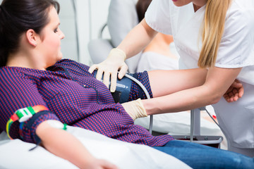 Nurse applying access for blood drawing and shots at upper arm of patient