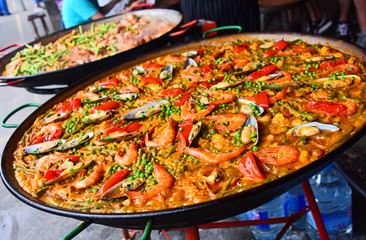 Spanish paella prepared in the street restaurant - obrazy, fototapety, plakaty