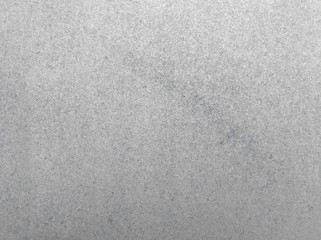 Old silver paint smears close-up on concrete wall surface. Abstract stained grunge background