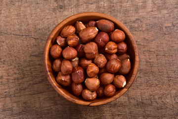 Hazelnuts bowl on wooden background
