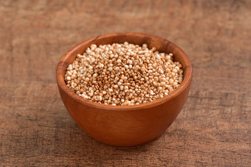 Sorghum seed bowl on wooden background