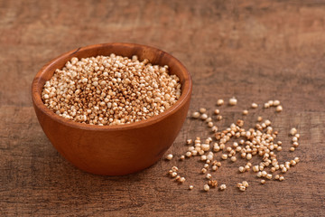 Sorghum seed bowl on wooden background