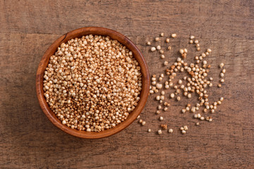 Sorghum seed bowl on wooden background