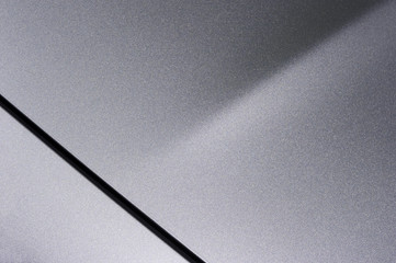 Surface of gray sport sedan car, detail of metal hood and bumper of vehicle bodywork - 216840741