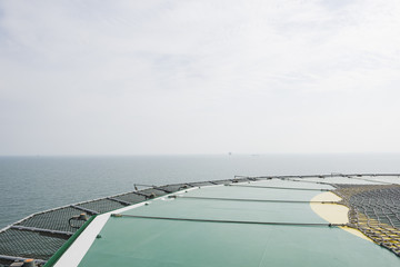 Naklejka na ściany i meble Offshore helicopter platform. Empty oil rig helipad. Sea and sky
