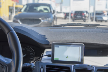 A car with a Navigator is located in the street Parking of the shopping center