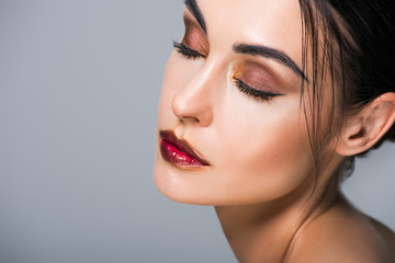 Fototapeta premium portrait of young tender woman with fashionable makeup, isolated on grey