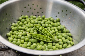 Fresh green peas in a strainer 