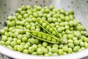 Fresh green peas in a strainer 