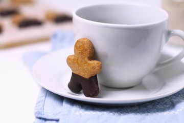 Gingerbread man cookie with a cup of tea