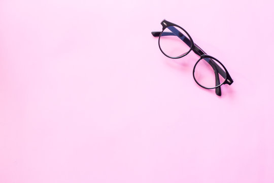 glasses or sunglasses object fashion minimal modern style, accessory travel on Pink pastel color background. Top view