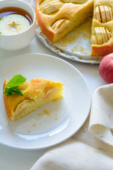 Slice of homemade apple pie on white plate. Tea time concept