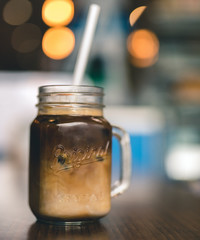 Iced coffee in a cafe with out of focus lights in background