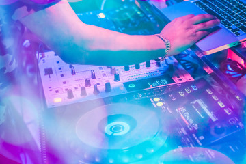 DJs are turntablism turntables plate mixer night party pub Motion blur wite light sunset abstract background. instagram style filter photo vintage tone