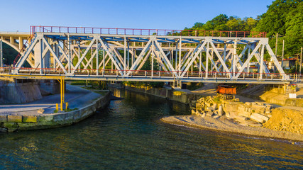 Drone front view of the railway bridge over the Matsesta river in sunny summer day, Sochi, Russia
