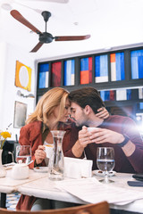Emotional connection. Musing adorable couple drinking coffee and caressing