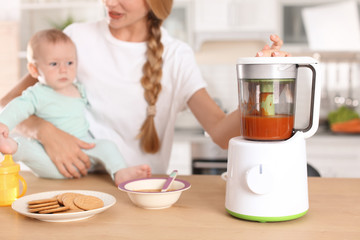 Woman preparing breakfast for her child in kitchen. Healthy baby food